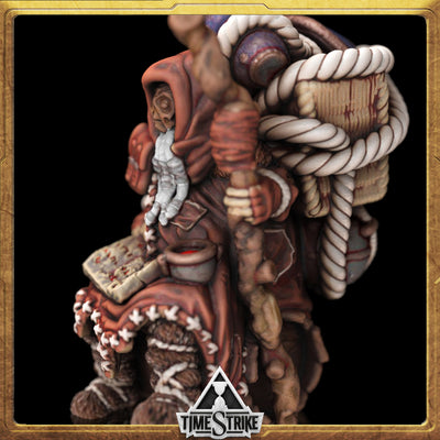 Hod Founders miniature side close-up — hooded sage with puppet and spellbook in red robes for TimeStrike & tabletop wargaming