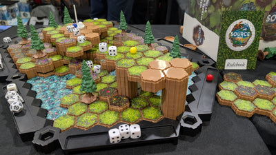 SOURCE Golf elevated hex course in play — multi-tier fairway with raised cliff pillars, water hazard, pine tree obstacles, dice and yellow ball mid-game