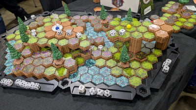 SOURCE Golf course overview — full multi-elevation hex fairway with water hazard, pine trees, dice trays and ball marker for tabletop golf game demo